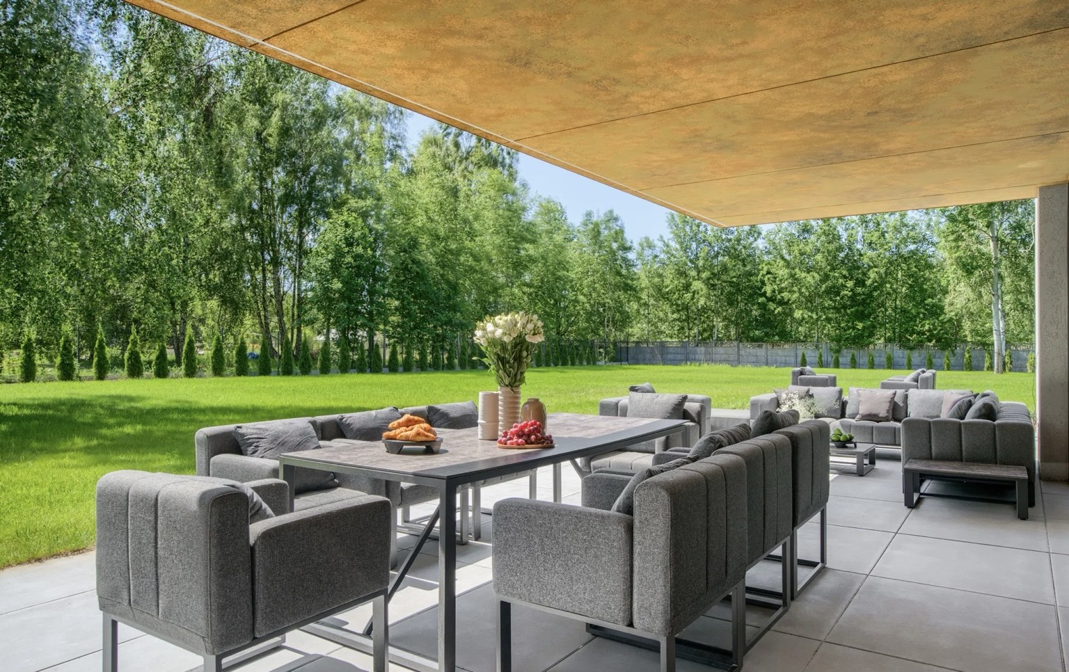 Dining table and lounge area on a spacious covered terrace