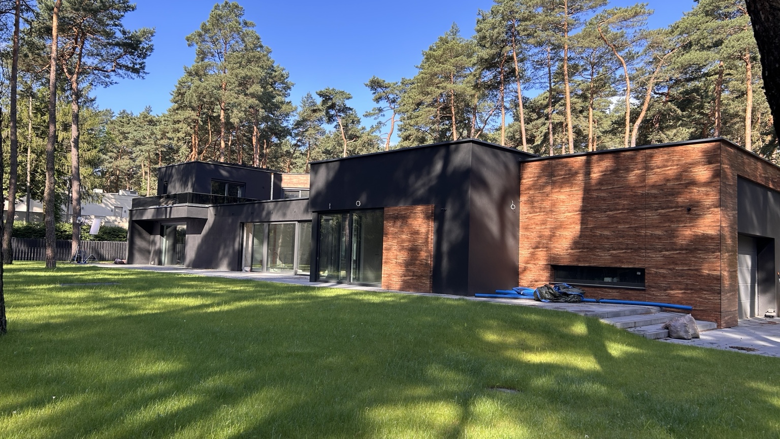 Front of a modern residence in a forest setting