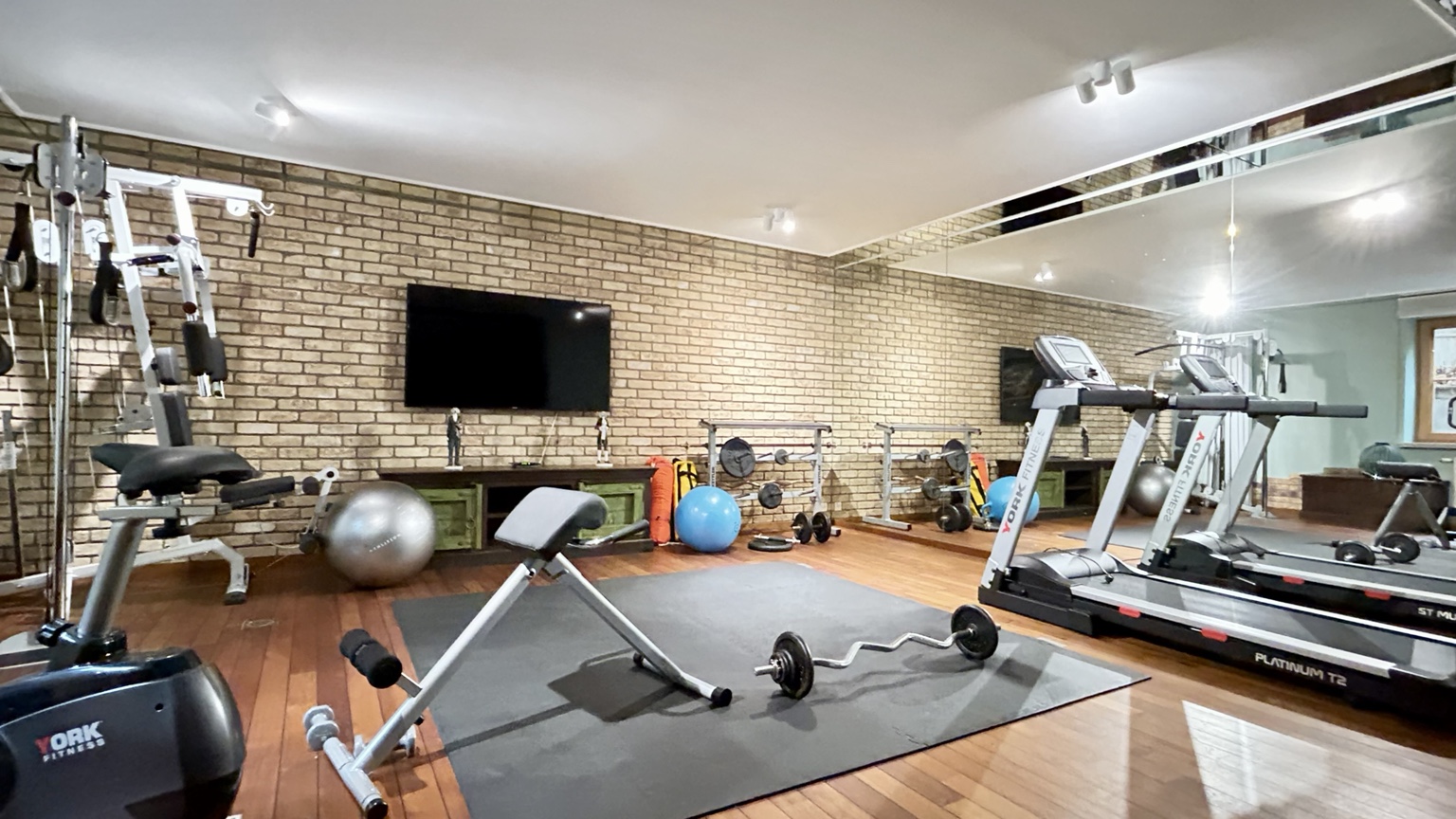 Private fitness room with cardio and strength equipment