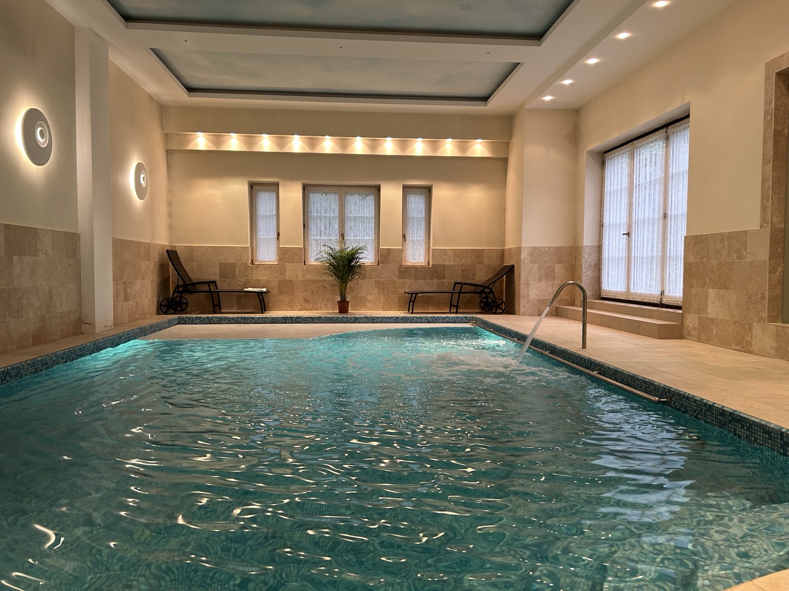 Indoor swimming pool with warm lighting