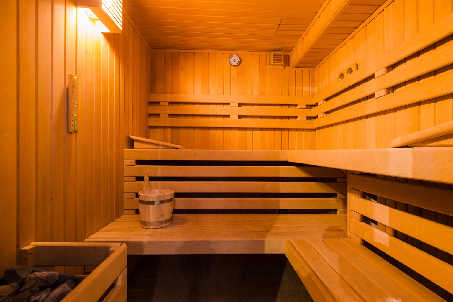 Wooden sauna with warm amber lighting
