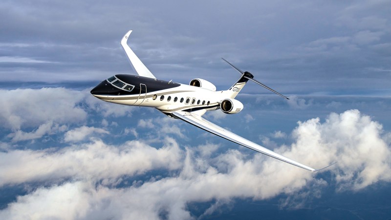 Private jet flying above the clouds