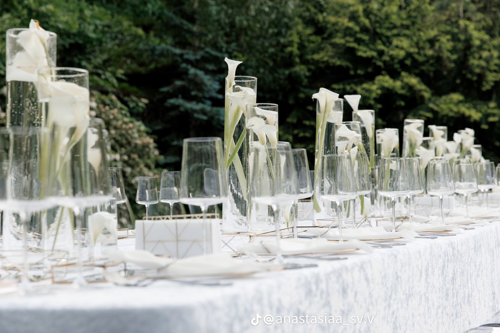 White flowers in glass vases on a wedding table